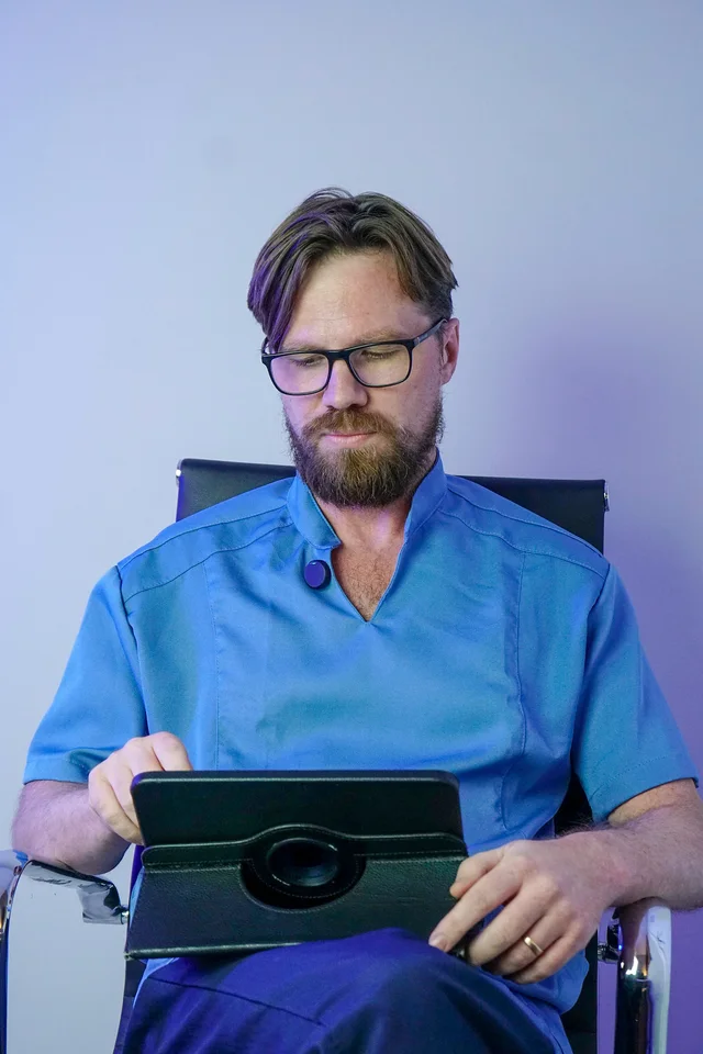 Andrei Cuzuioc utilizando um tablet no contexto do atendimento.